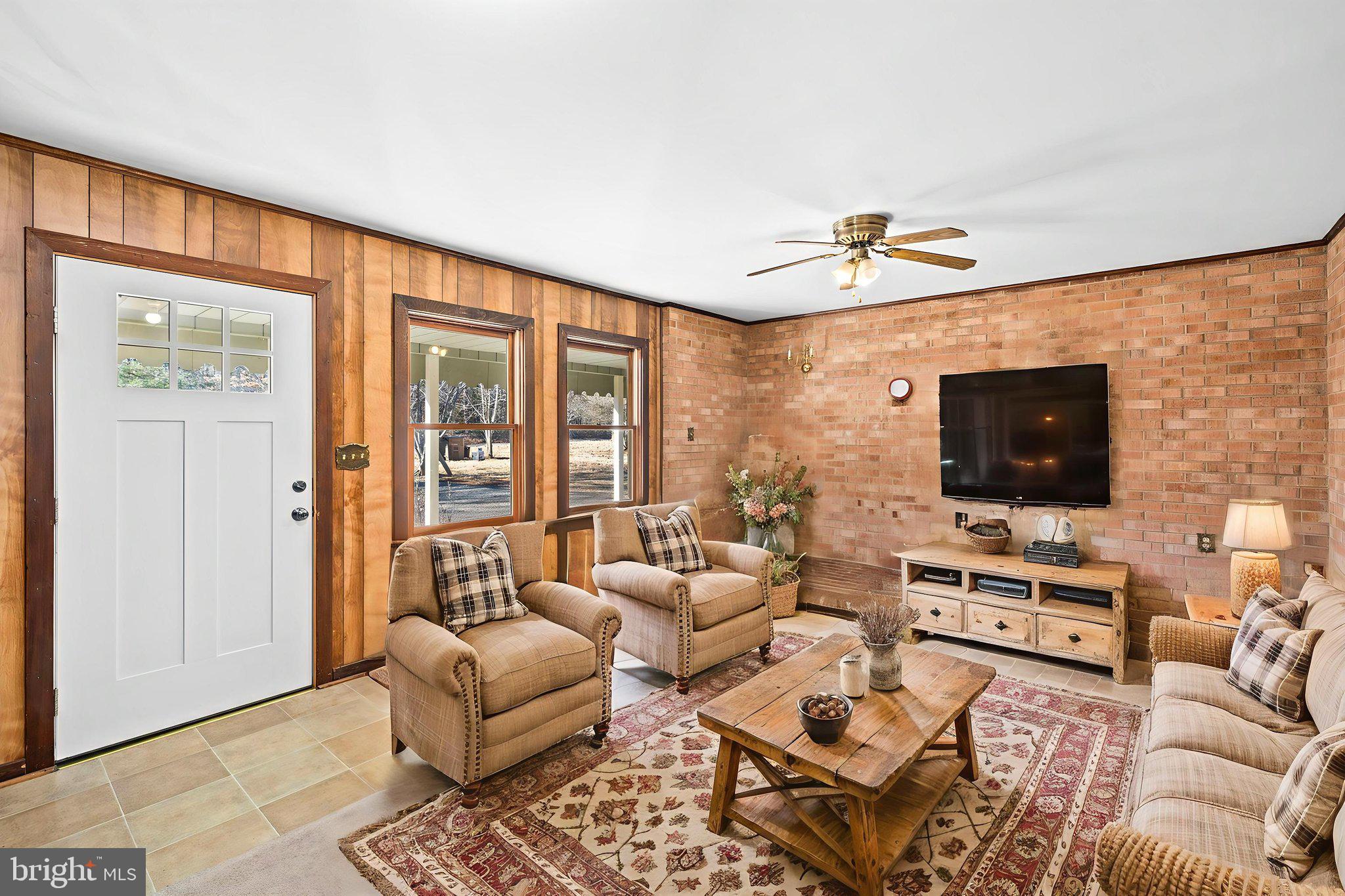 16125 Mountain Track Road Orange, VA 22960 - Photo 11 of 60 a living room with furniture and a flat screen tv