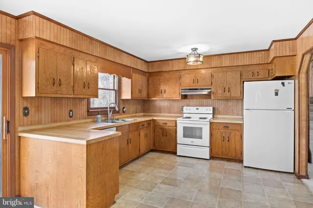 a stove top oven sitting inside of a kitchen