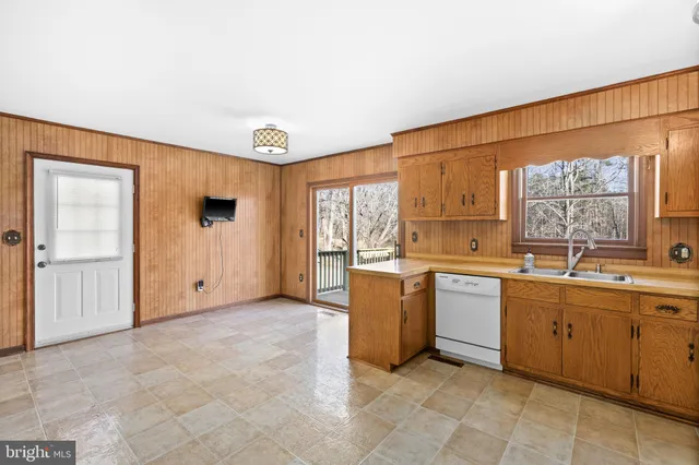 a view of a dining room with furniture window and kitchen view