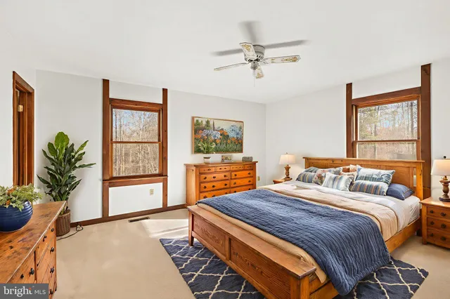an empty room with a window and a ceiling fan