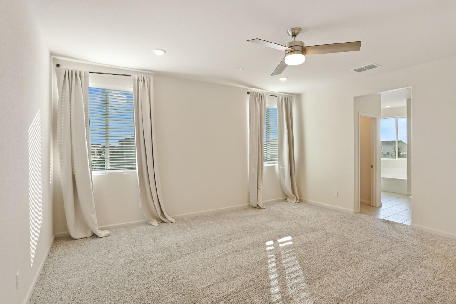 2004 Ravine Lane Manteca, CA 95337 - Photo 15 of 28 an empty room with closet and a ceiling fan
