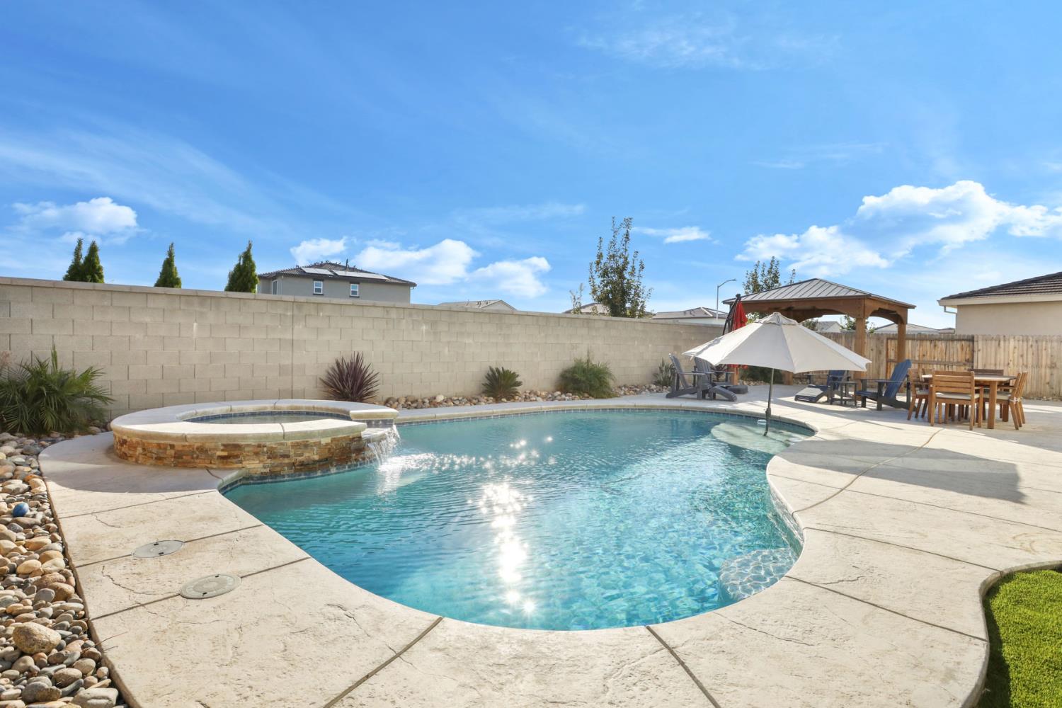 2004 Ravine Lane Manteca, CA 95337 - Photo 24 of 28 a view of a swimming pool with a yard