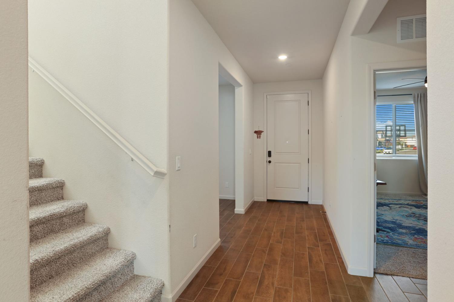 2004 Ravine Lane Manteca, CA 95337 - Photo 3 of 28 a view of a hallway with wooden floor and entryway