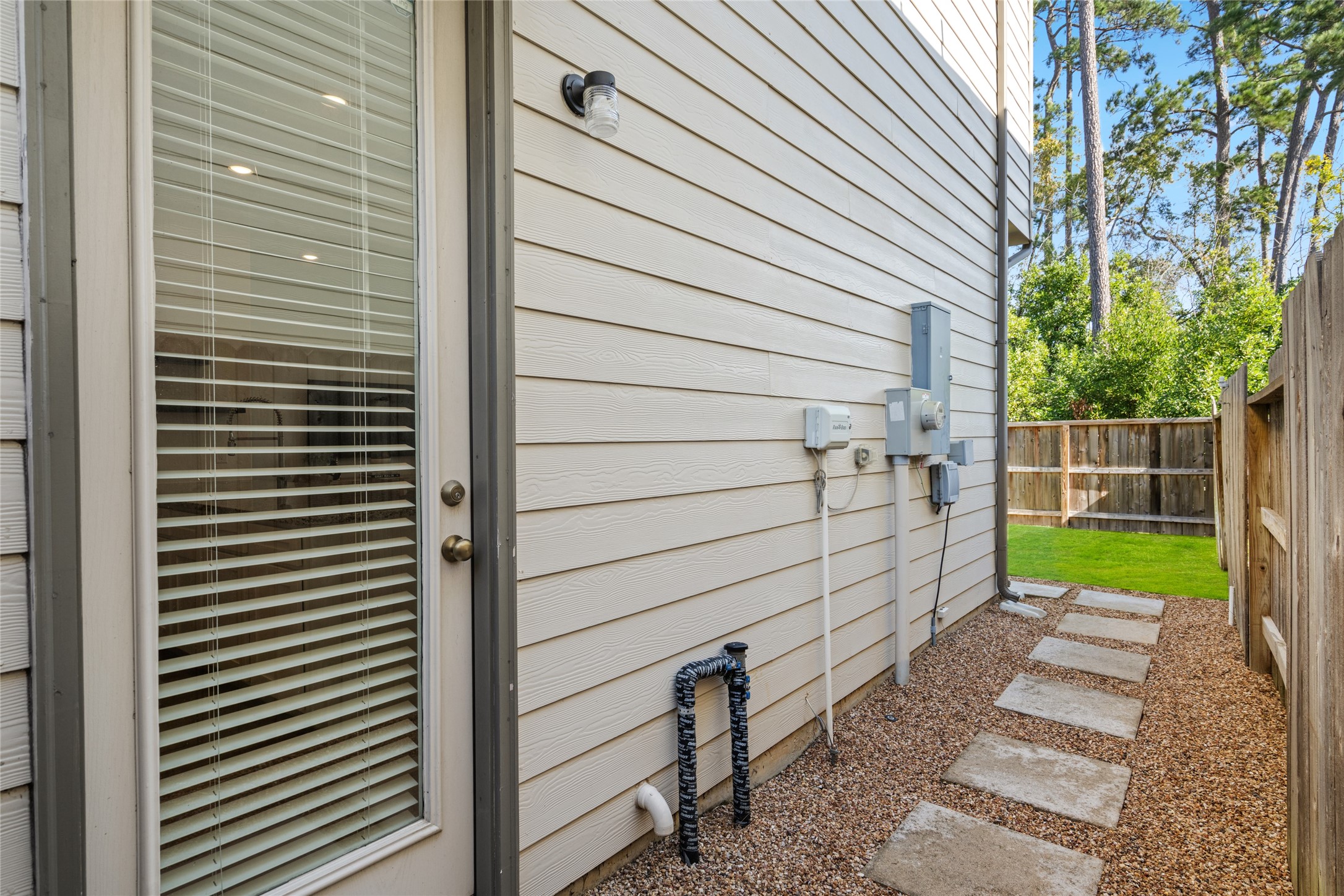 575 Dry Fork Lane Conroe, TX 77304 - Photo 26 of 34 Stepping stone side yard path with low- maintenance gravel providing direct access to the backyard.