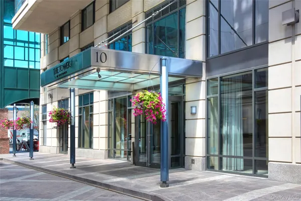 a front view of a multi story building with yard