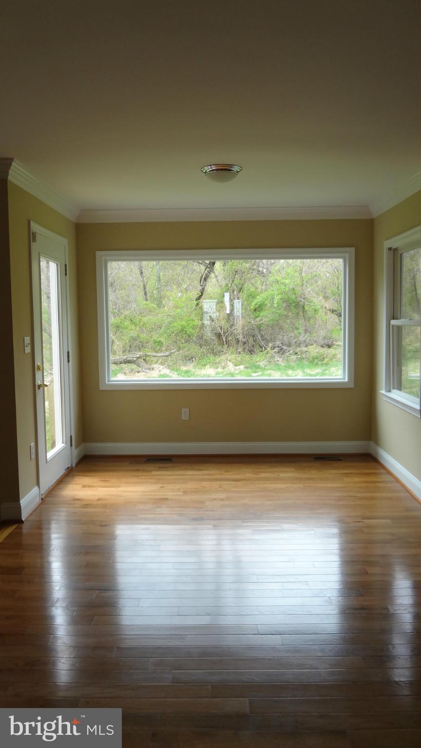 6800 Olney Laytonsville Road Laytonsville, MD 20882 - Photo 3 of 13 a view of empty room with wooden floor and fan