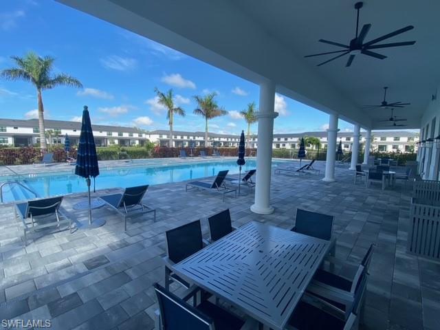 7596 Morgan Way Naples, FL 34119 - Photo 29 of 35 a view of a patio with a dining table and chairs