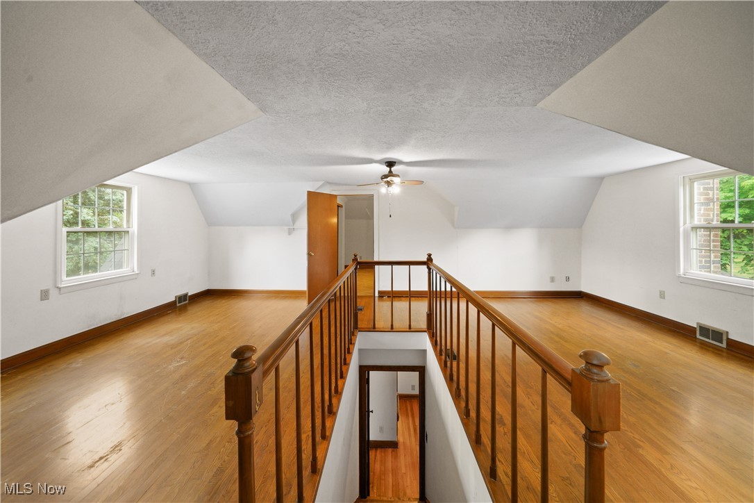 4088 Manchester Road Akron, OH 44319 - Photo 27 of 50 Staircase with wood finished floors, vaulted ceiling, baseboards, a textured ceiling, and a ceiling fan