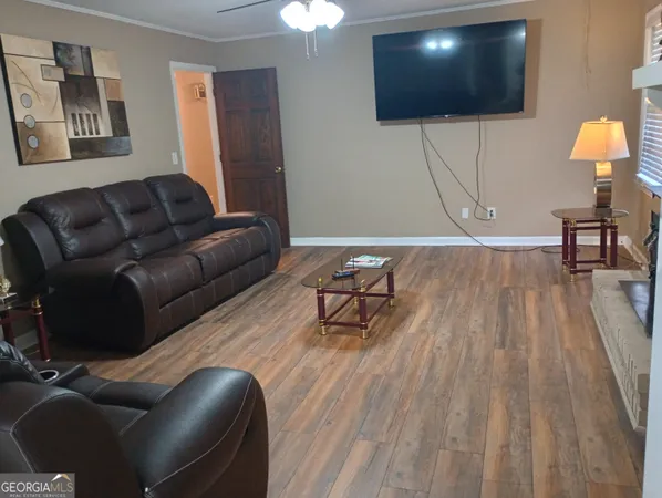 a living room with furniture and a flat screen tv