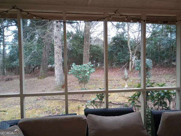 a view of a living room and a floor to ceiling window
