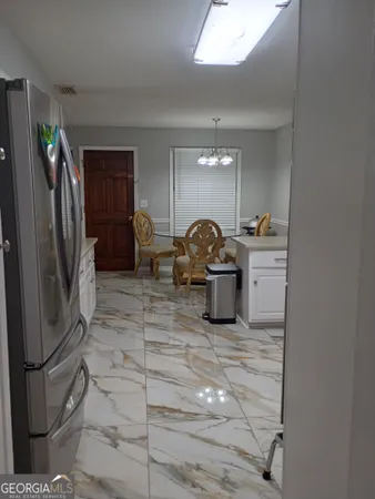 a kitchen with stainless steel appliances a sink a stove a refrigerator and cabinets