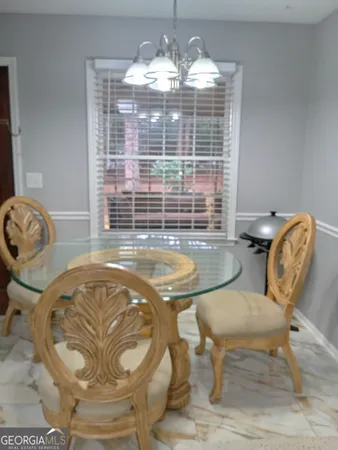 a view of a dining room with furniture and chandelier