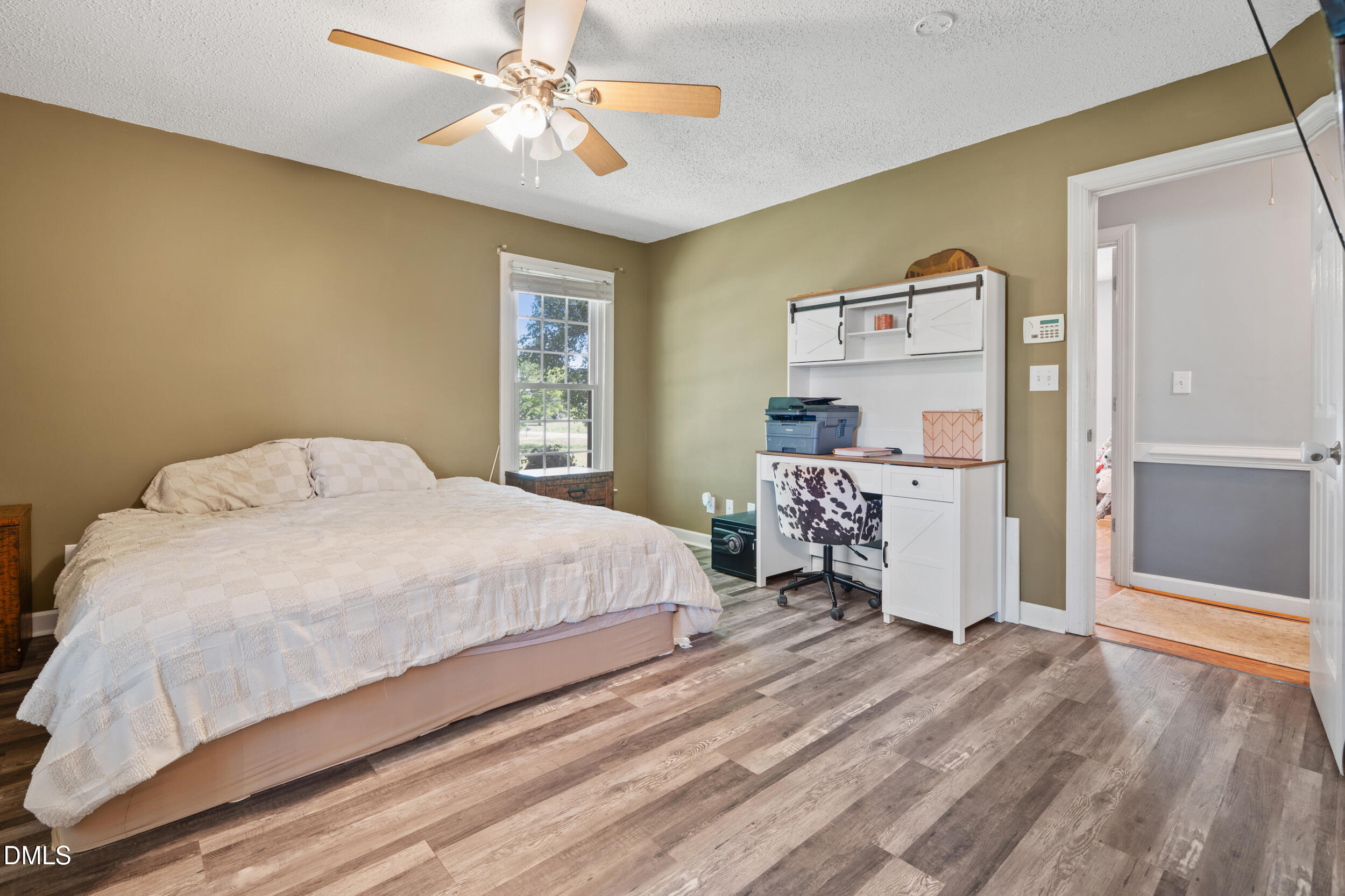 311 Bridgers Road Kenly, NC 27542 - Photo 23 of 46 a spacious bedroom with a bed and a chandelier