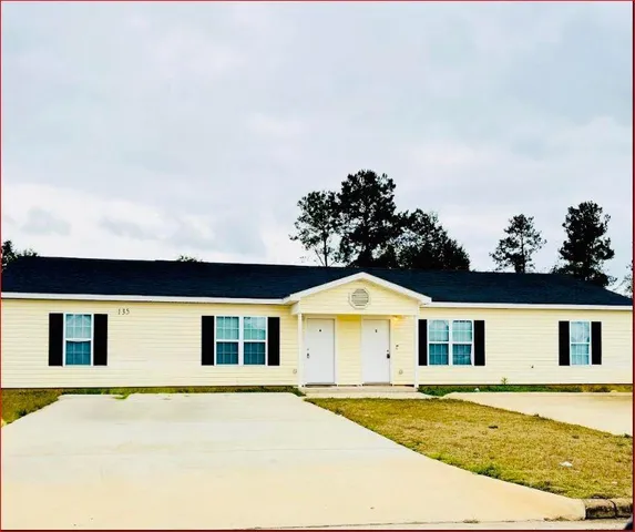 a view of an house with backyard and kitchen