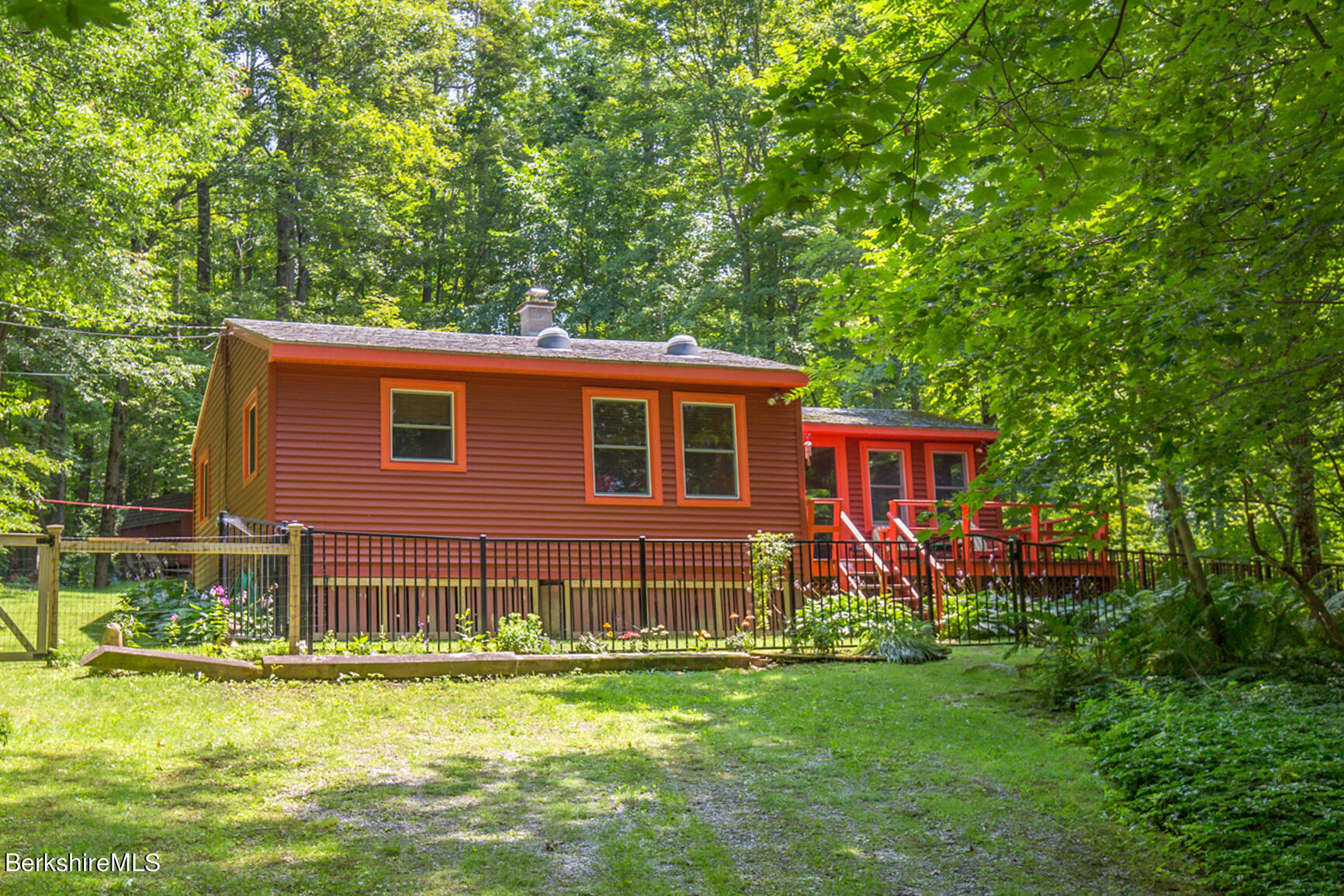 1 Massasoit Road Stockbridge, MA 01262 - Photo 2 of 28 a front view of a house with a yard table and chairs