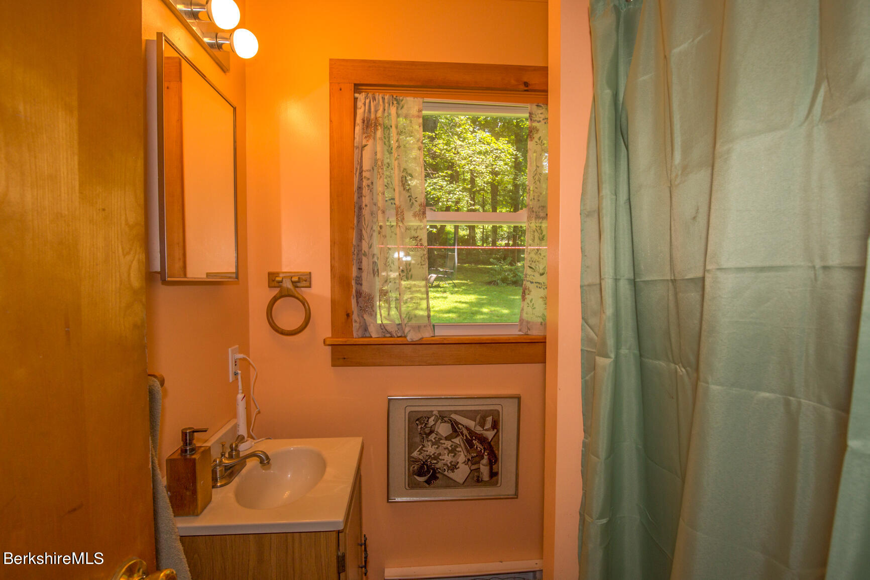 1 Massasoit Road Stockbridge, MA 01262 - Photo 18 of 28 a bathroom with a sink a mirror and a window