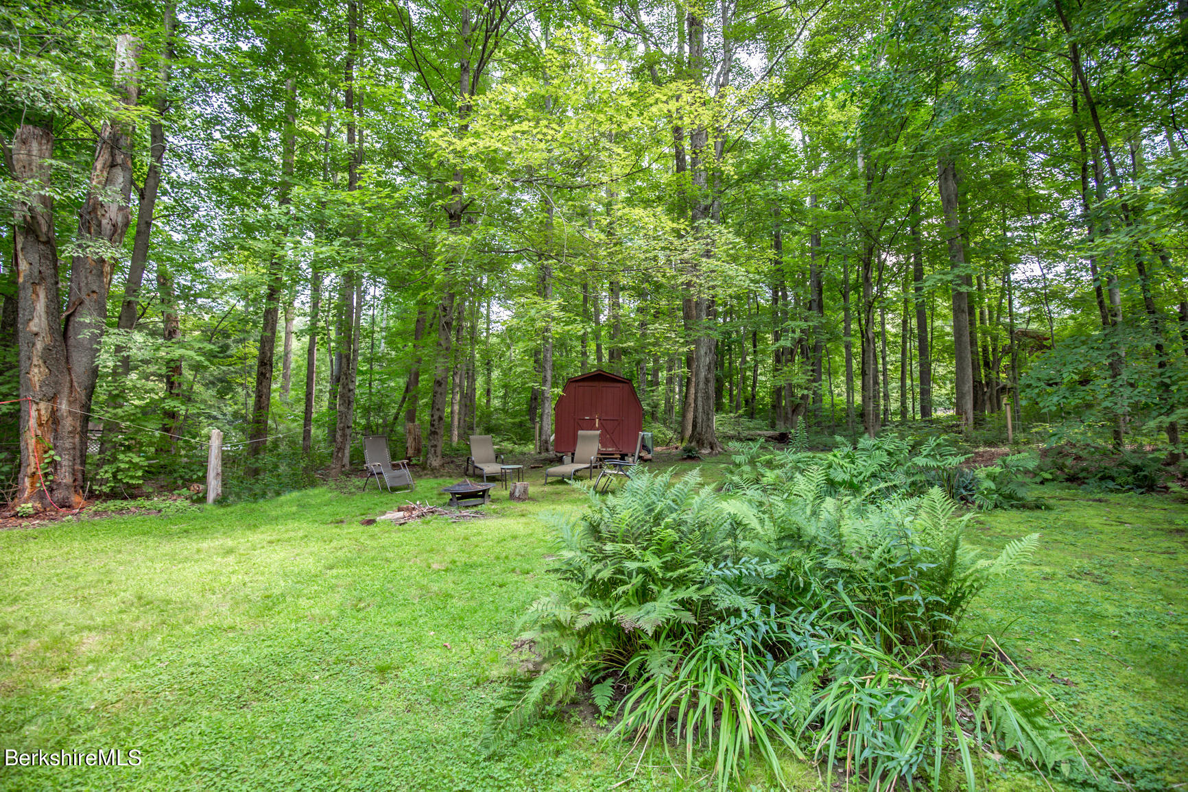 1 Massasoit Road Stockbridge, MA 01262 - Photo 22 of 28 a backyard of a house with a garden and entertaining space