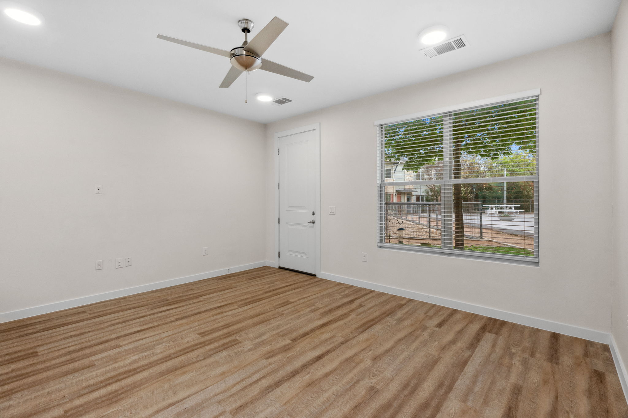 7805 Cooper Lane, Unit 606 Austin, TX 78745 - Photo 14 of 35 an empty room with wooden floor and windows