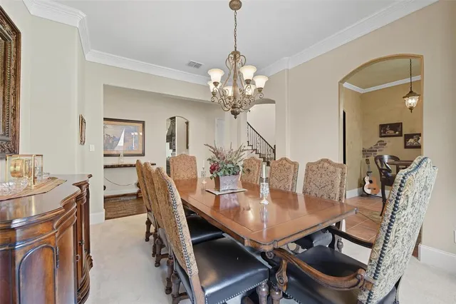 a view of a dining room with furniture and a chandelier