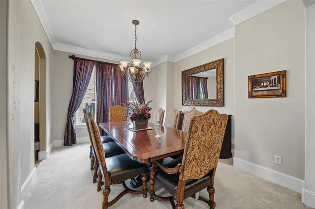 a dining room with furniture and chandelier