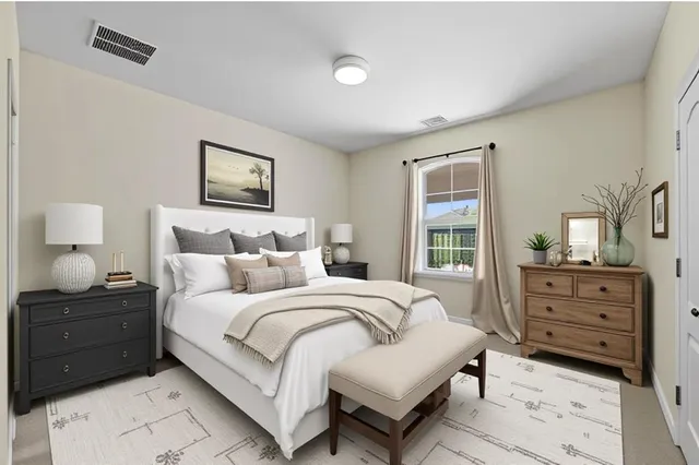 a bedroom with a bed and a dresser