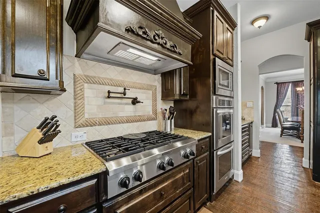 a stove top oven sitting inside of a kitchen