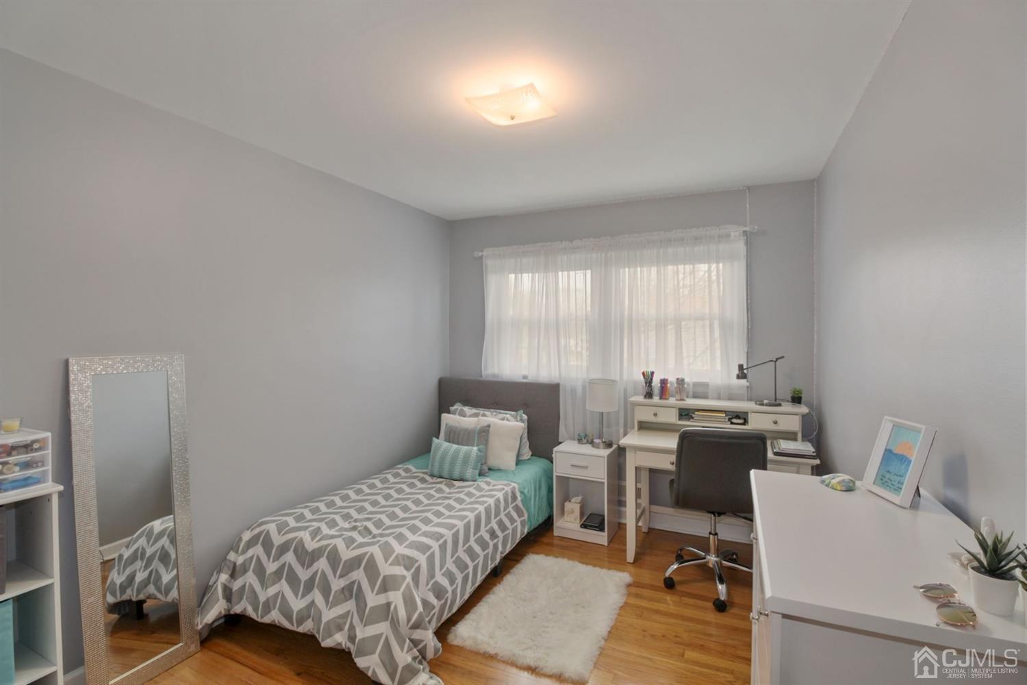 12 Hudson Road East Brunswick, NJ 08816 - Photo 15 of 30 a bedroom with a bed and wooden floor