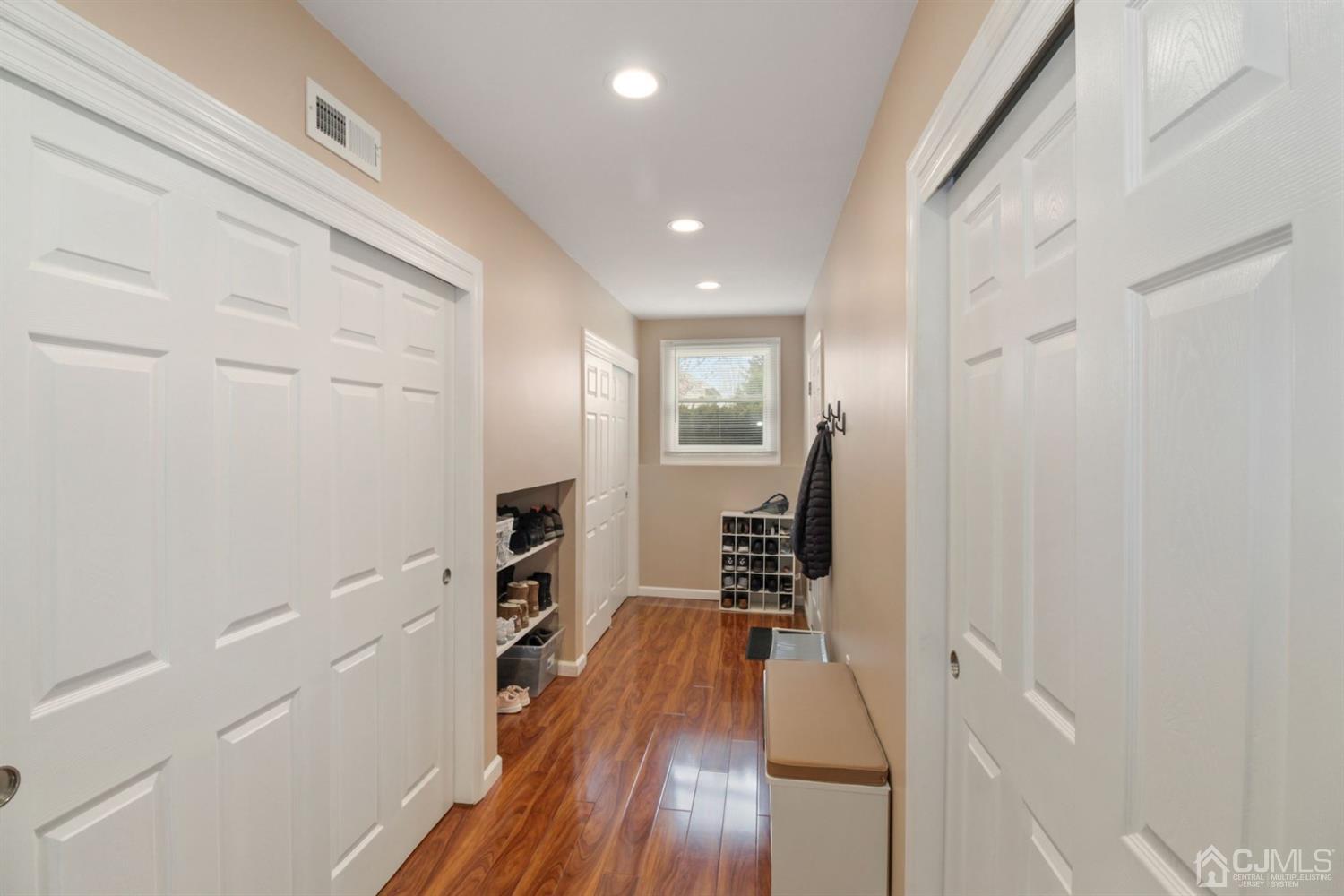 12 Hudson Road East Brunswick, NJ 08816 - Photo 19 of 30 a hallway with wooden floor fireplace and cabinets
