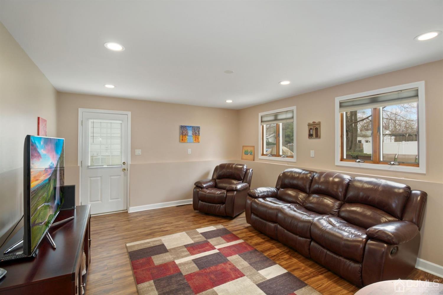 12 Hudson Road East Brunswick, NJ 08816 - Photo 20 of 30 a living room with furniture and a flat screen tv