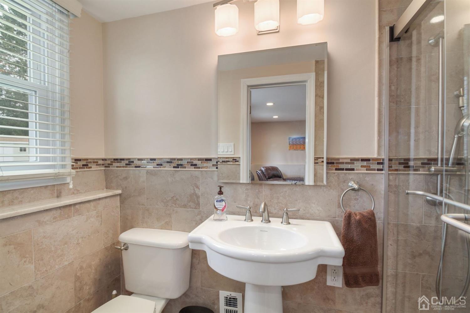 12 Hudson Road East Brunswick, NJ 08816 - Photo 22 of 30 a bathroom with a sink toilet and a mirror