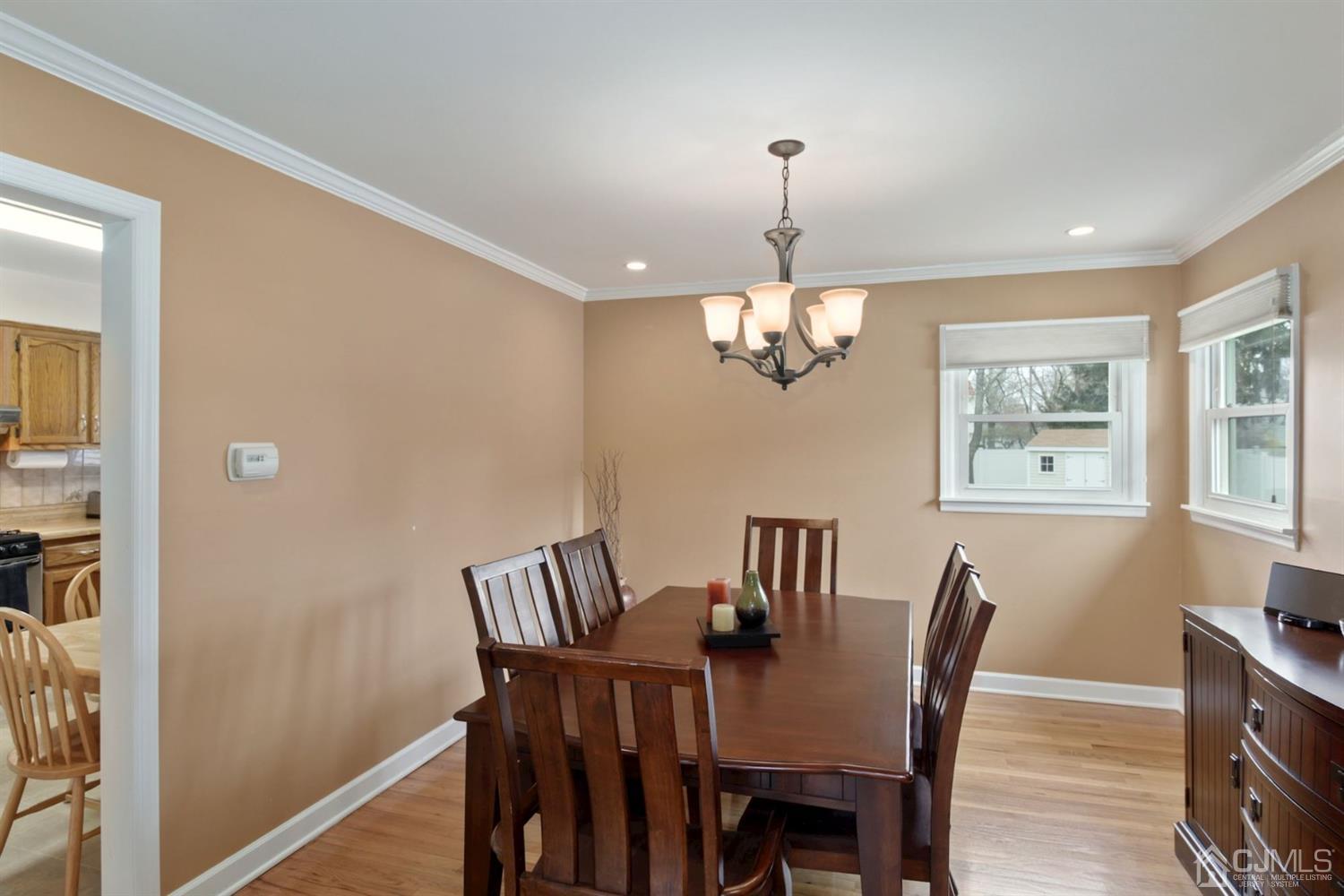 12 Hudson Road East Brunswick, NJ 08816 - Photo 7 of 30 a view of a dining room with furniture a chandelier and wooden floor