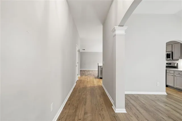 a view of a room with wooden floor