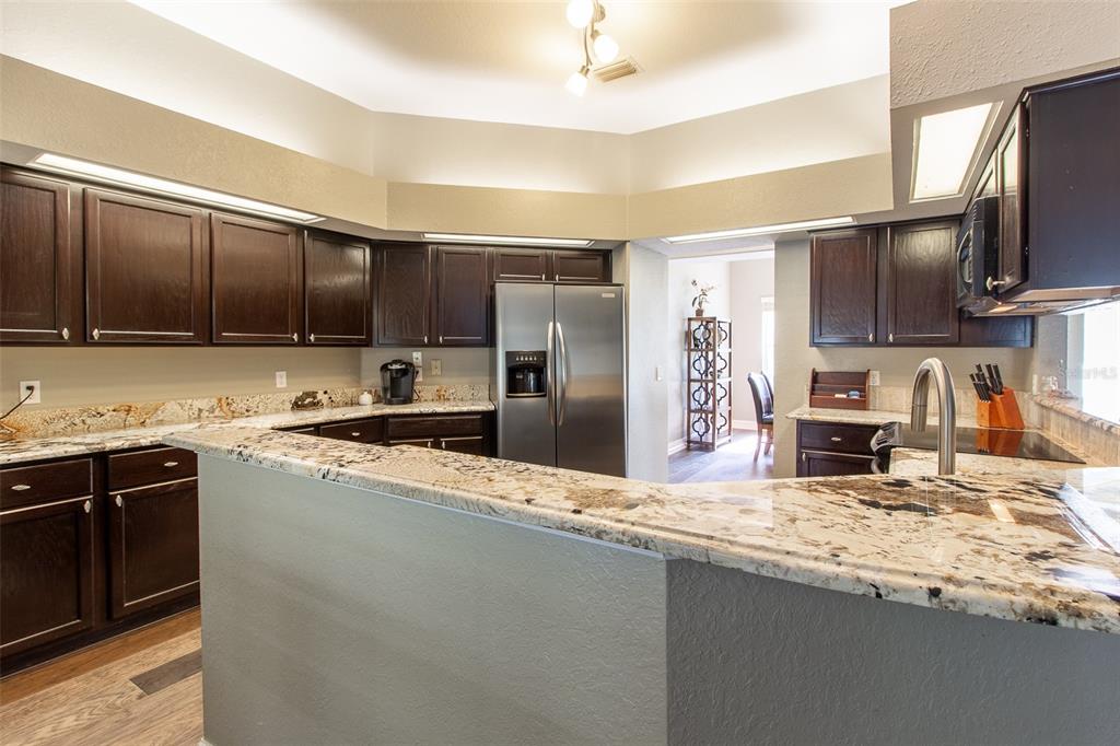 8950 Southeast 17th Court Ocala, FL 34480 - Photo 14 of 61 a kitchen with stainless steel appliances granite countertop a stove refrigerator and sink