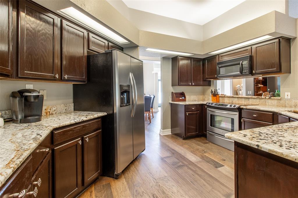 8950 Southeast 17th Court Ocala, FL 34480 - Photo 15 of 61 a kitchen with granite countertop stainless steel appliances and wooden cabinets