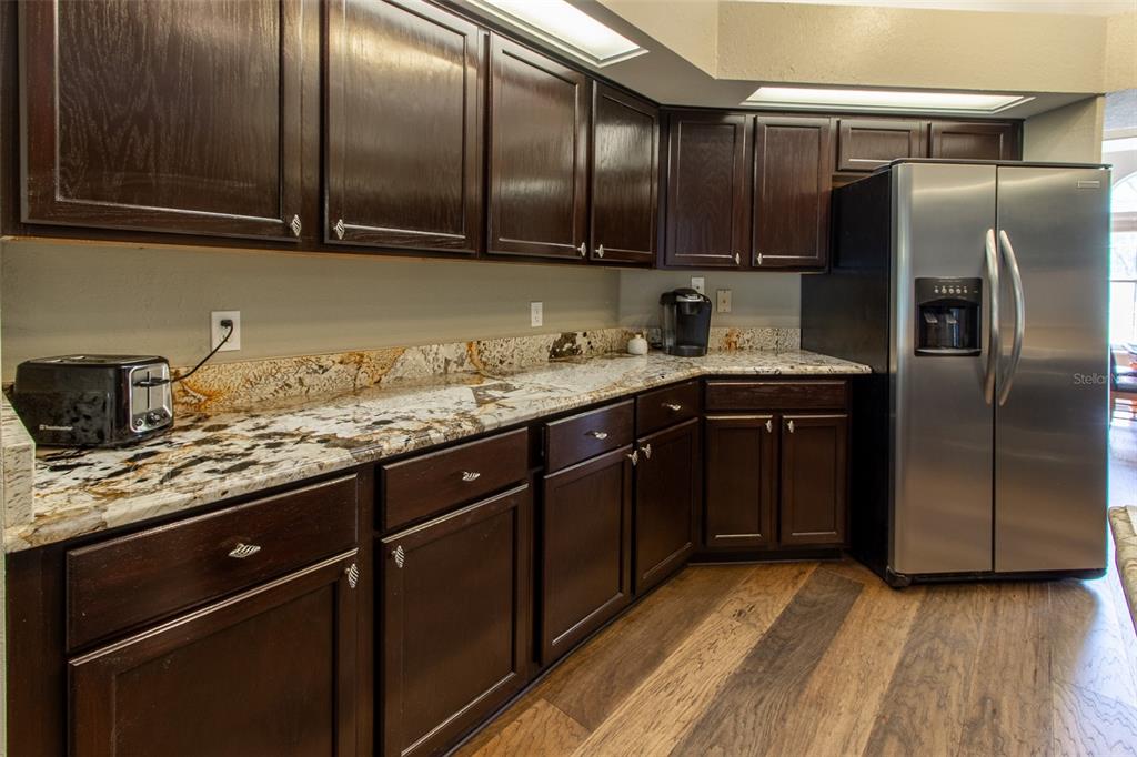 8950 Southeast 17th Court Ocala, FL 34480 - Photo 16 of 61 a kitchen with granite countertop stainless steel appliances a sink and cabinets