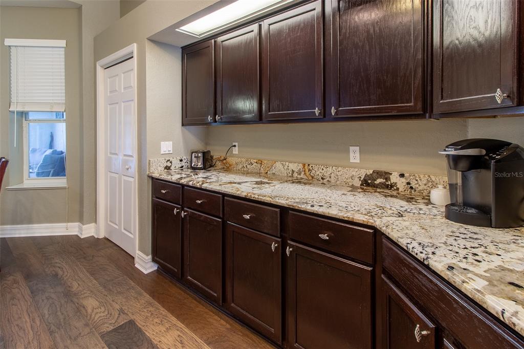 8950 Southeast 17th Court Ocala, FL 34480 - Photo 18 of 61 a kitchen with granite countertop stainless steel appliances stove microwave and cabinets