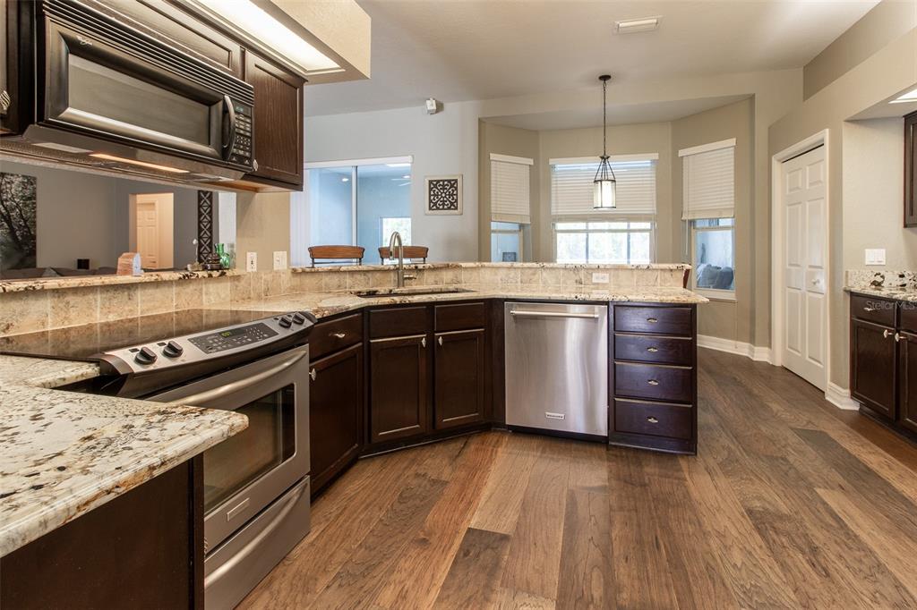 8950 Southeast 17th Court Ocala, FL 34480 - Photo 19 of 61 a kitchen with stainless steel appliances granite countertop a stove and a sink