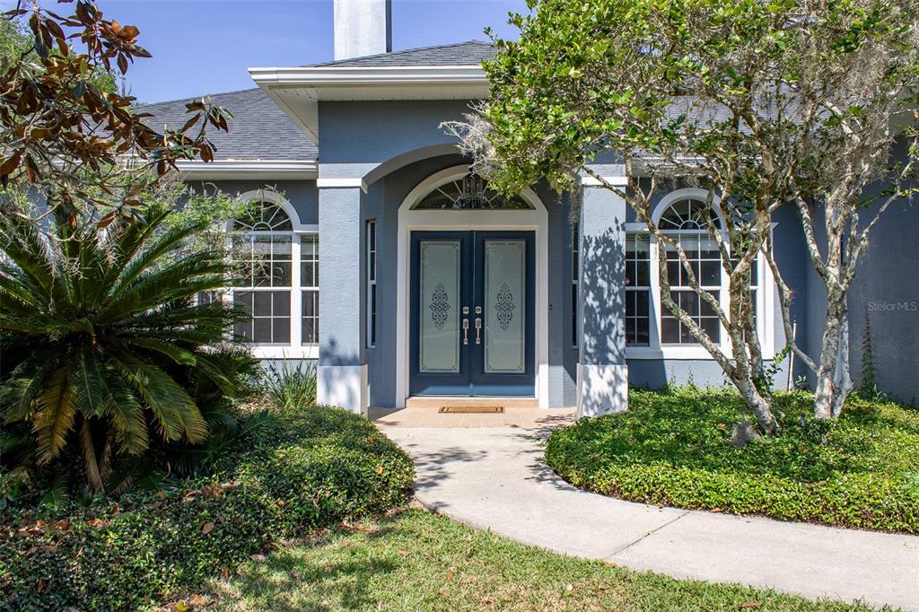 8950 Southeast 17th Court Ocala, FL 34480 - Photo 2 of 61 a front view of a house with a garden