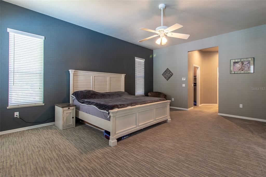 8950 Southeast 17th Court Ocala, FL 34480 - Photo 21 of 61 a living room with a bed furniture and a chandelier