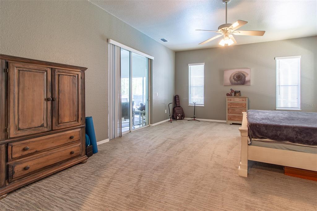 8950 Southeast 17th Court Ocala, FL 34480 - Photo 22 of 61 a bedroom with furniture and window