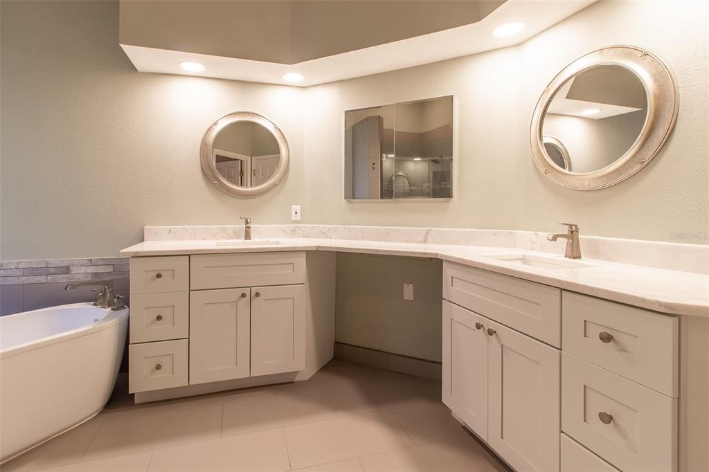 8950 Southeast 17th Court Ocala, FL 34480 - Photo 24 of 61 a spacious bathroom with a double vanity sink double mirror and a bathtub