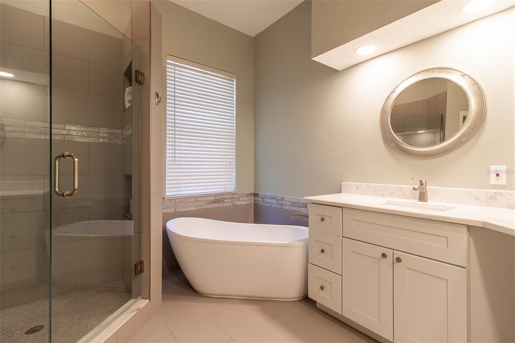 8950 Southeast 17th Court Ocala, FL 34480 - Photo 25 of 61 a bathroom with a bathtub sink mirror and toilet