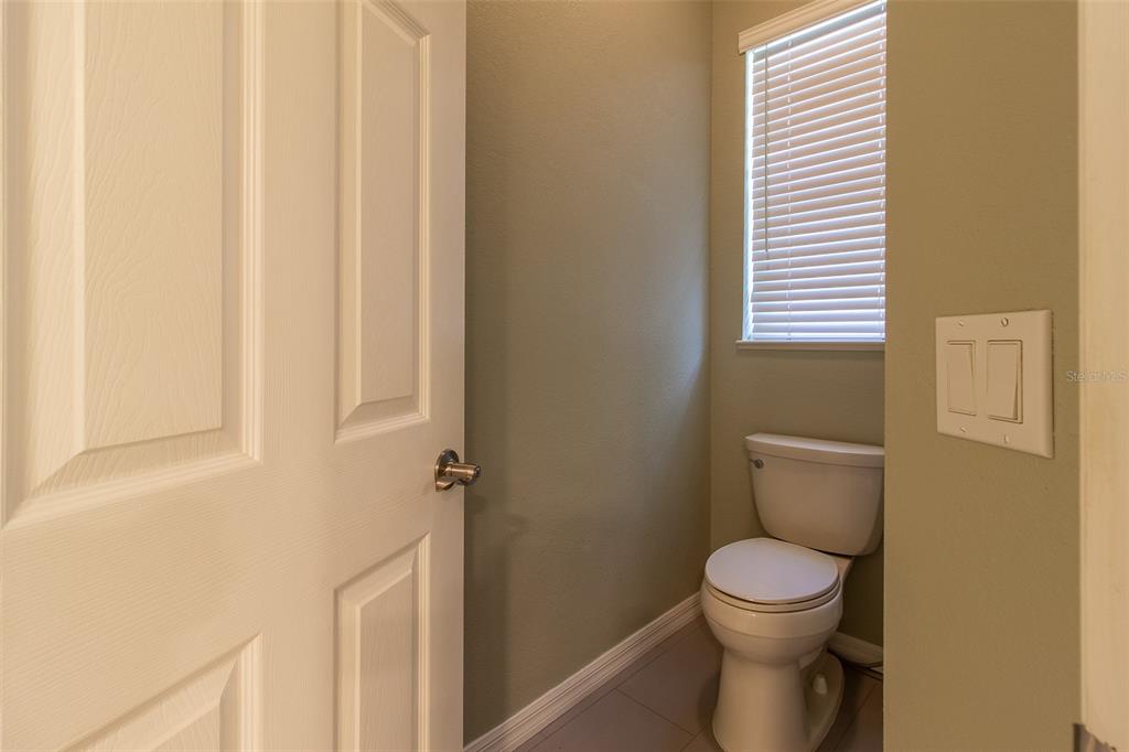 8950 Southeast 17th Court Ocala, FL 34480 - Photo 26 of 61 a white toilet sitting next to a bathroom sink