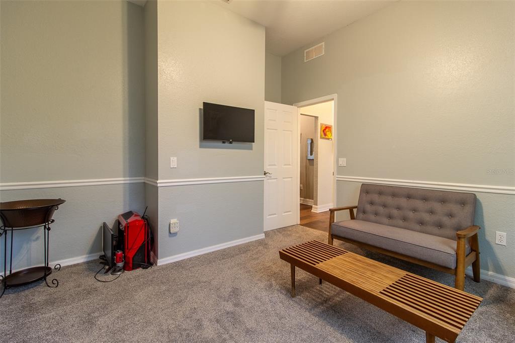 8950 Southeast 17th Court Ocala, FL 34480 - Photo 29 of 61 a living room with furniture a flat screen tv and a window