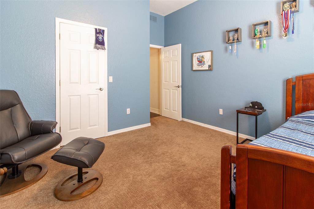 8950 Southeast 17th Court Ocala, FL 34480 - Photo 32 of 61 a bedroom with furniture and wooden floor