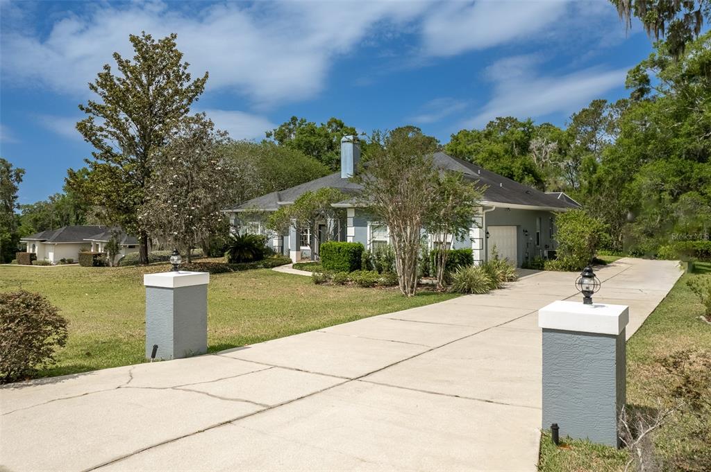 8950 Southeast 17th Court Ocala, FL 34480 - Photo 46 of 61 a view of a house with backyard sitting area and garden