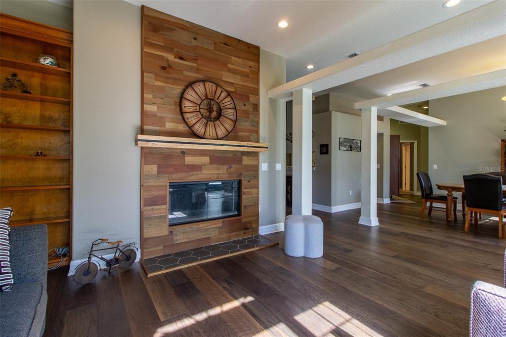 8950 Southeast 17th Court Ocala, FL 34480 - Photo 6 of 61 a living room with wooden floor and a fireplace