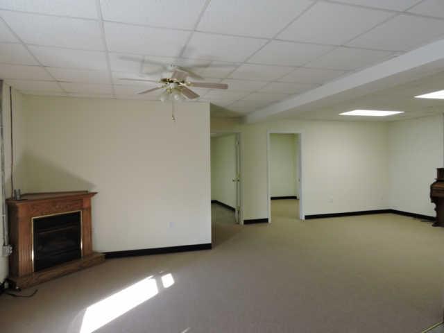 1406 Mud Creek Road Morrison, TN 37357 - Photo 13 of 20 a view of a livingroom with a ceiling fan and a fireplace