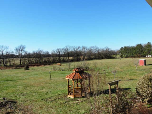 1406 Mud Creek Road Morrison, TN 37357 - Photo 18 of 20 a lake view with a bench and trees around