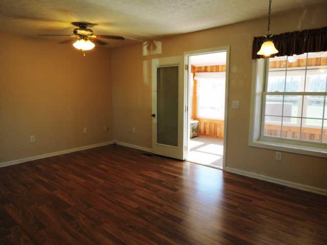 1406 Mud Creek Road Morrison, TN 37357 - Photo 4 of 20 a view of empty room with wooden floor and fan